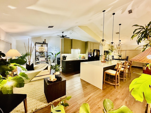 9494 Sun Pointe Dr, Boynton Beach, FL 33437 - kitchen featuring light countertops, vaulted ceiling, a sink, a breakfast bar area, and a ceiling fan