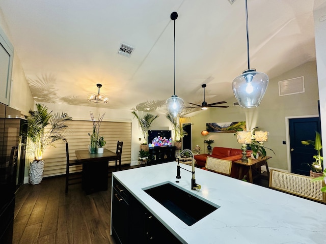 9494 Sun Pointe Dr, Boynton Beach, FL 33437 - kitchen featuring a sink, dark wood finished floors, pendant lighting, a chandelier, and vaulted ceiling