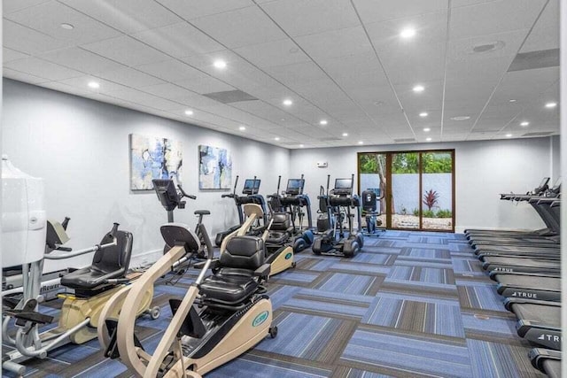 gym featuring a drop ceiling, recessed lighting, and carpet