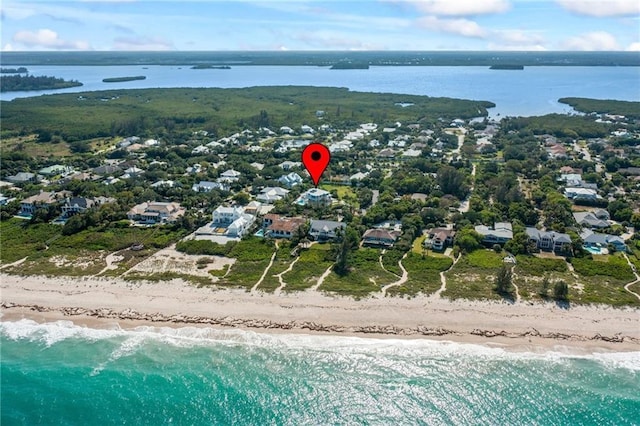 drone / aerial view with a water view, a residential view, and a beach view