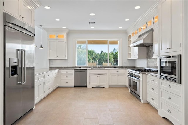 kitchen featuring white cabinets, a sink, built in appliances, under cabinet range hood, and ornamental molding
