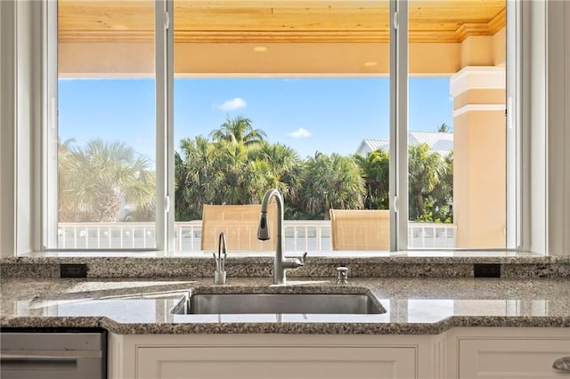 kitchen featuring white cabinetry, a wealth of natural light, a sink, and dishwasher