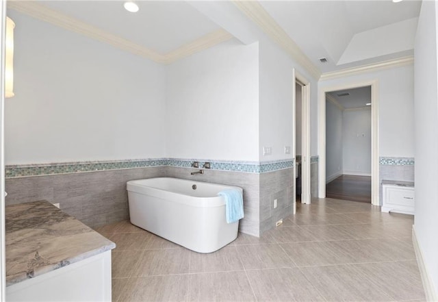 full bath with tile walls, wainscoting, and ornamental molding