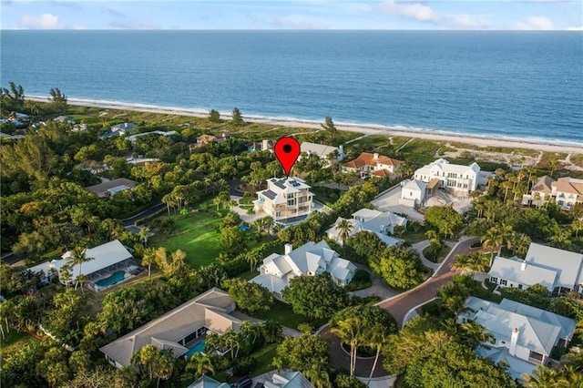 aerial view with a water view, a residential view, and a view of the beach
