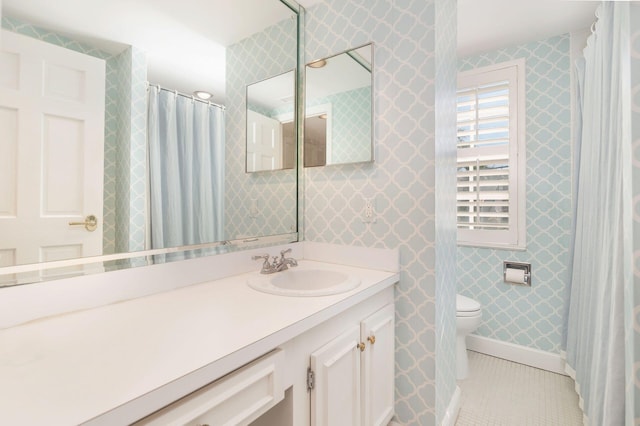 bathroom with toilet, tile patterned flooring, and vanity