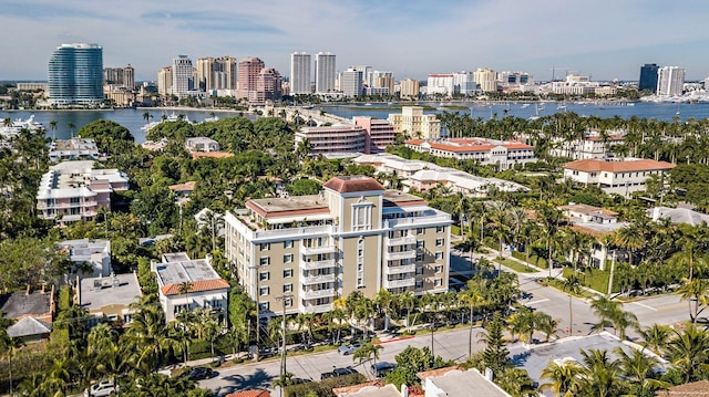 drone / aerial view featuring a city view and a water view