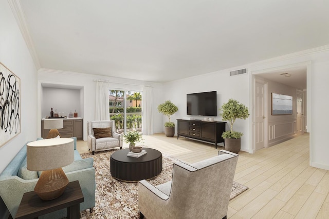 living area with crown molding, visible vents, and light wood-style flooring