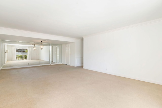 empty room with light carpet and crown molding