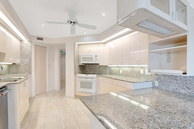 4605 S Ocean Blvd Unit 4C, Highland Beach, FL 33487 - kitchen with white appliances, a sink, a ceiling fan, light stone counters, and backsplash