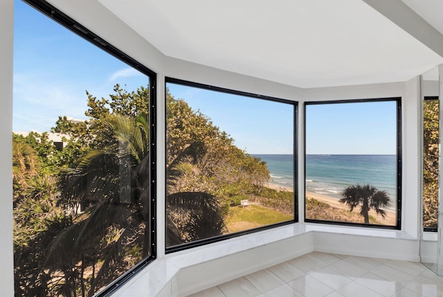 4605 S Ocean Blvd Unit 4C, Highland Beach, FL 33487 - unfurnished sunroom with tile patterned floors and view of water and beach