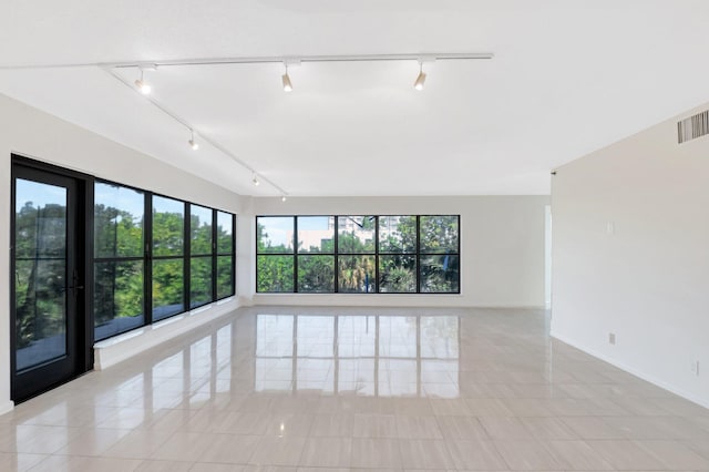 4605 S Ocean Blvd Unit 4C, Highland Beach, FL 33487 - empty room featuring track lighting, light tile patterned floors, and baseboards