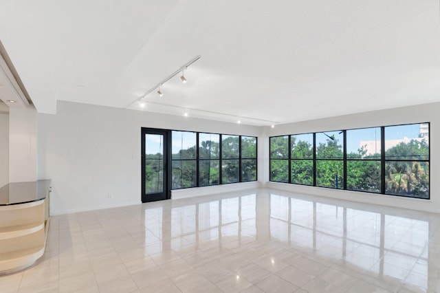 4605 S Ocean Blvd Unit 4C, Highland Beach, FL 33487 - unfurnished room with rail lighting, light tile patterned floors, and plenty of natural light