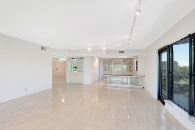 4605 S Ocean Blvd Unit 4C, Highland Beach, FL 33487 - unfurnished living room with rail lighting and light tile patterned floors