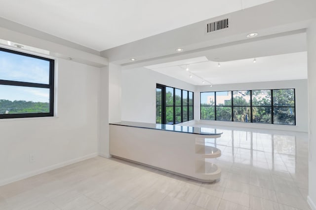4605 S Ocean Blvd Unit 4C, Highland Beach, FL 33487 - empty room with baseboards, rail lighting, and light tile patterned floors