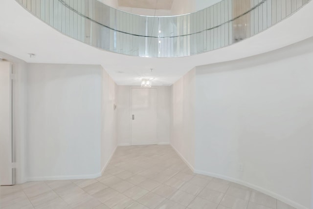 4605 S Ocean Blvd Unit 4C, Highland Beach, FL 33487 - spare room featuring a high ceiling and baseboards