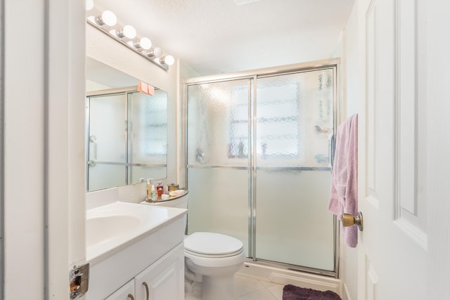 325 Tilford P, Deerfield Beach, FL 33442 - bathroom featuring toilet, tile patterned floors, vanity, and a stall shower