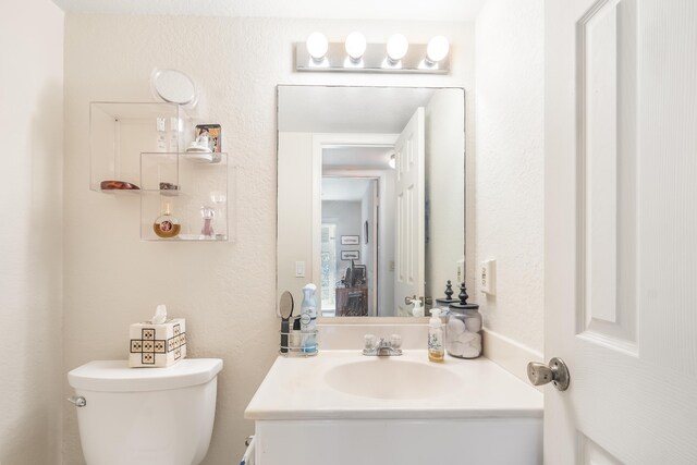 325 Tilford P, Deerfield Beach, FL 33442 - bathroom with a textured wall, toilet, and vanity