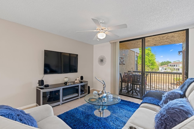 5661 Riverside Dr Unit 206B7, Coral Springs, FL 33067 - tiled living room with a textured ceiling, ceiling fan, and baseboards