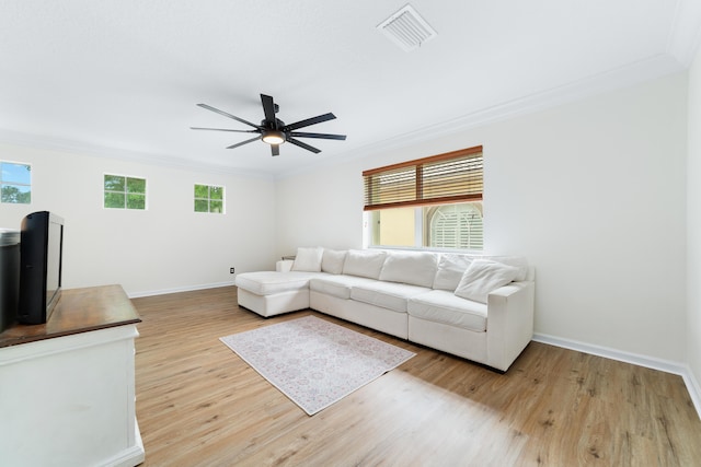 living room featuring visible vents, crown molding, and a ceiling fan