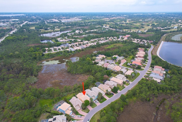 drone / aerial view featuring a water view and a residential view