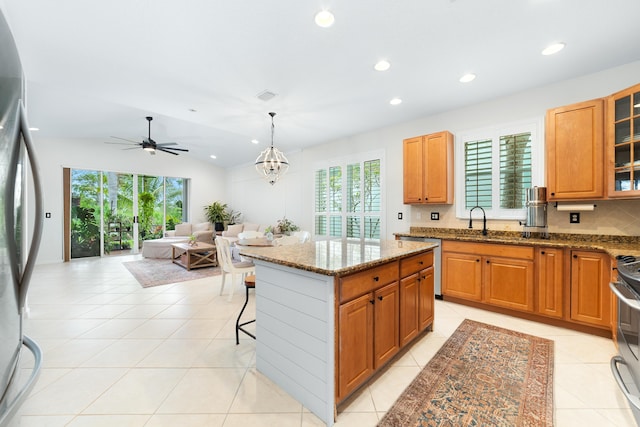kitchen featuring a ceiling fan, light tile patterned floors, and appliances with stainless steel finishes
