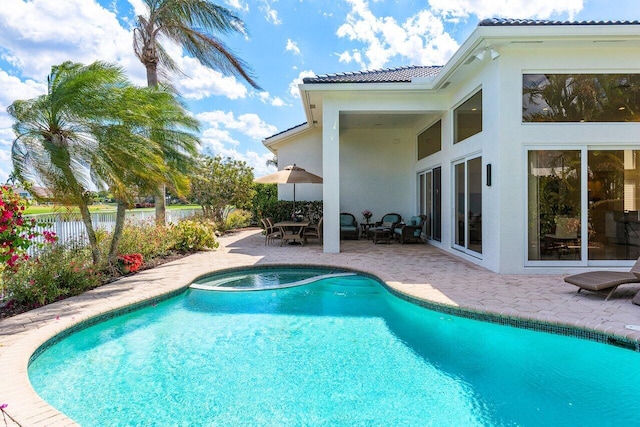 view of swimming pool with fence, a patio area, and a fenced in pool