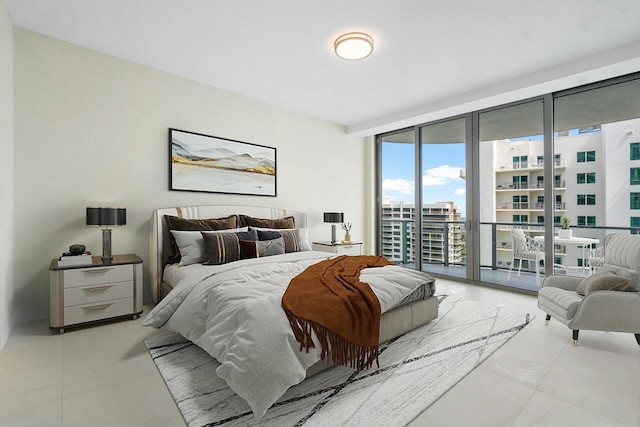 bedroom with light tile patterned flooring, expansive windows, access to exterior, and a city view