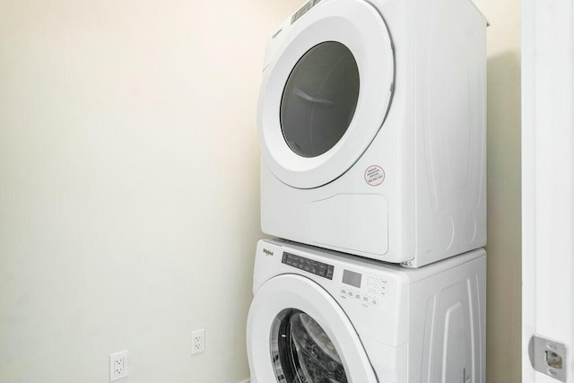 laundry room with stacked washing maching and dryer and laundry area