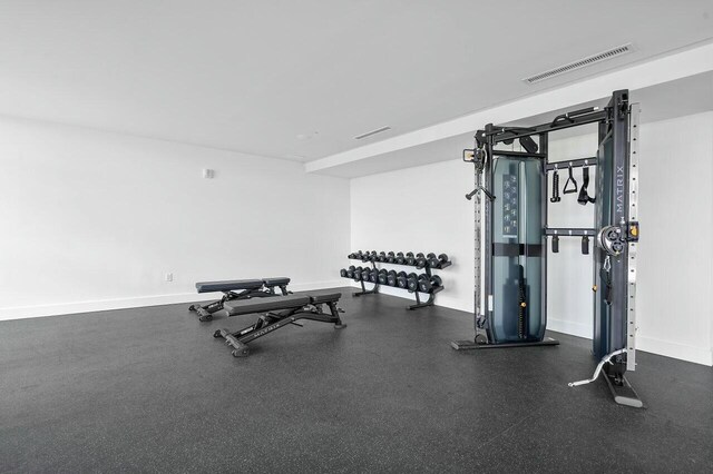 exercise room featuring baseboards and visible vents