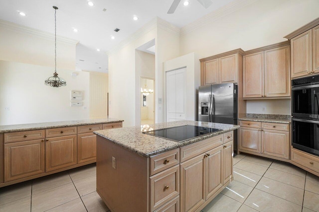 kitchen with crown molding, a kitchen island, light tile patterned flooring, light stone counters, and black appliances