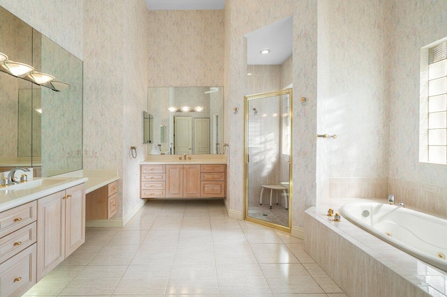 full bathroom featuring a stall shower, a tub with jets, wallpapered walls, and a sink