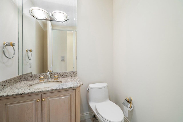 bathroom featuring toilet and vanity