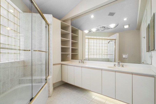 bathroom featuring double vanity, a sink, tile patterned floors, and shower / bath combination with glass door