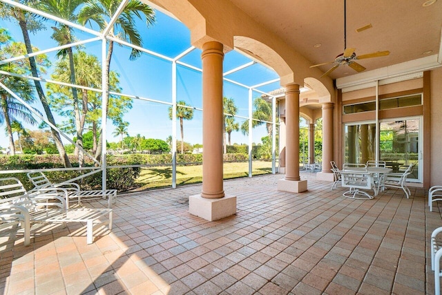 view of patio featuring a lanai, ceiling fan, and outdoor dining area