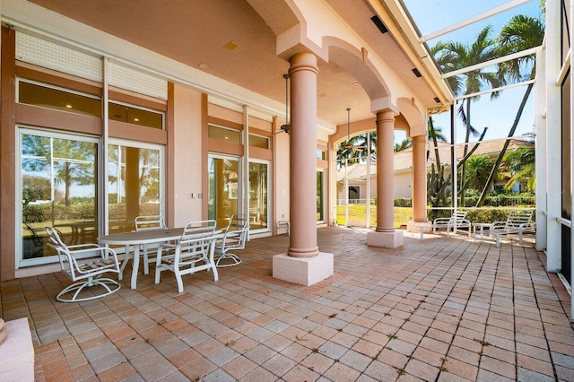 view of patio featuring a lanai