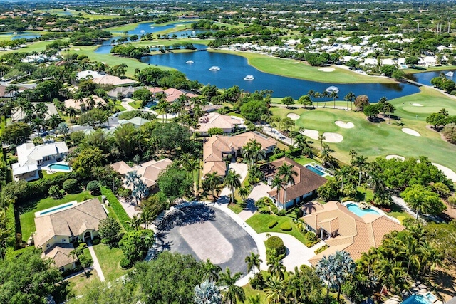 aerial view with a residential view, golf course view, and a water view
