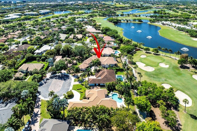 aerial view with view of golf course, a residential view, and a water view