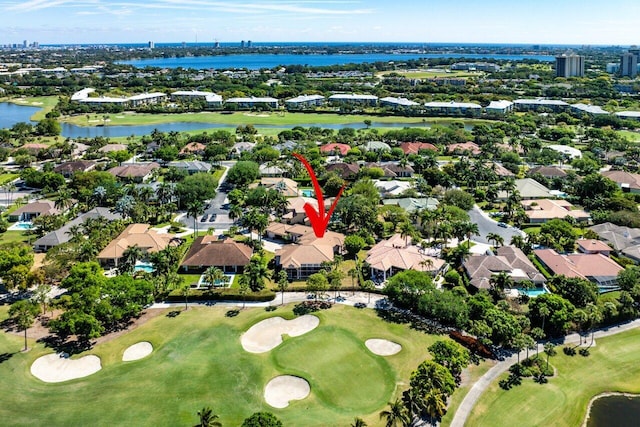 bird's eye view featuring golf course view, a water view, and a residential view