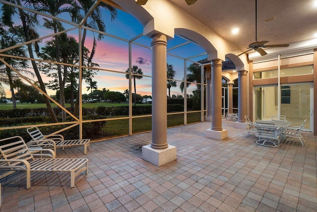 view of patio / terrace featuring a ceiling fan and a lanai