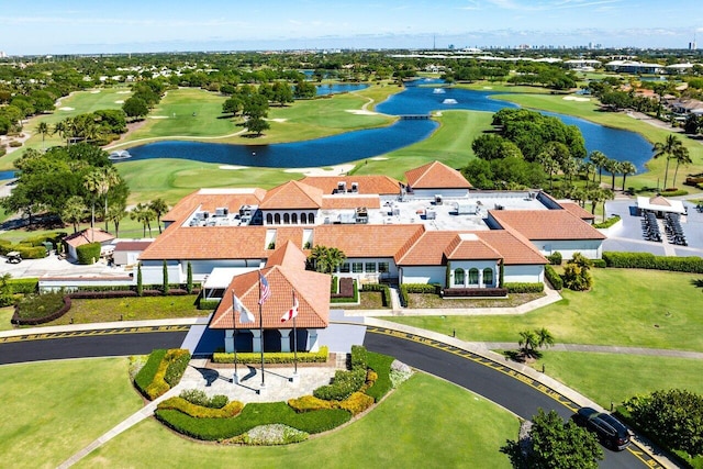 birds eye view of property with golf course view and a water view