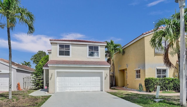 view of front of house featuring stucco siding, driveway, a garage, and a tiled roof