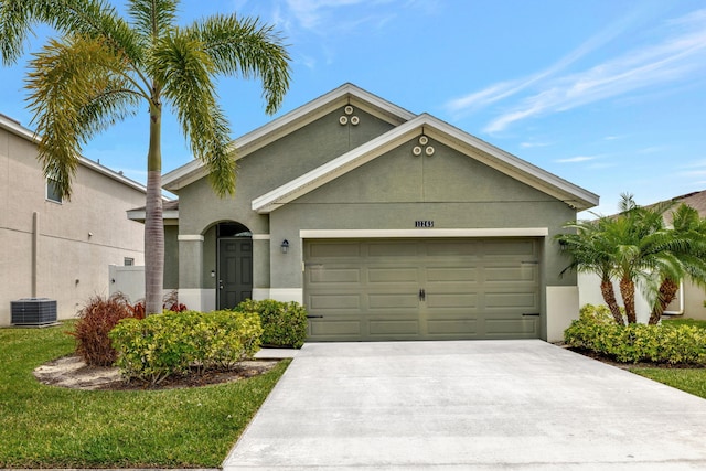 11265 SW Hadley St, Port Saint Lucie, FL 34987 - view of front of home with stucco siding, driveway, cooling unit, and a garage
