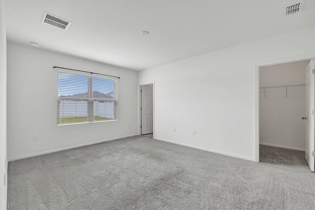 11265 SW Hadley St, Port Saint Lucie, FL 34987 - unfurnished bedroom featuring a spacious closet, baseboards, visible vents, and carpet