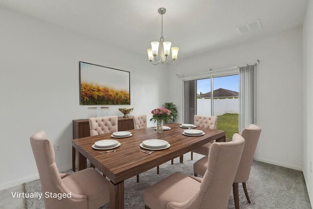 11265 SW Hadley St, Port Saint Lucie, FL 34987 - dining room with light colored carpet, baseboards, a notable chandelier, and visible vents