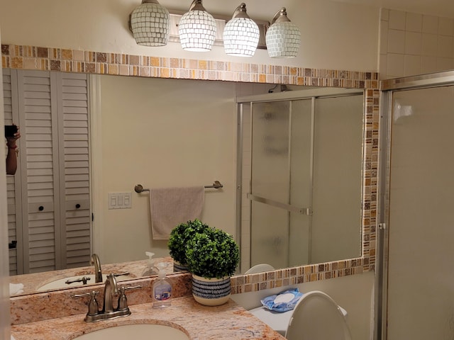 full bath featuring a stall shower and vanity