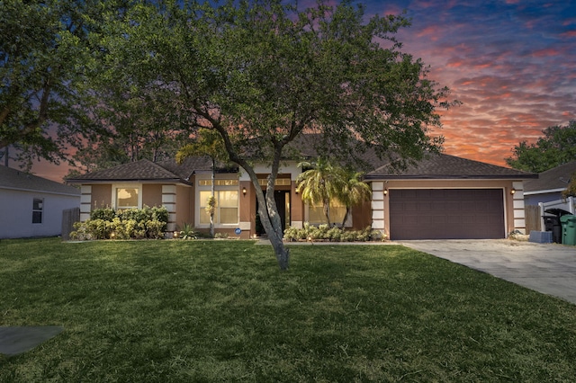 4226 SW Savona Blvd, Port Saint Lucie, FL 34953 - view of front of property featuring concrete driveway, stucco siding, an attached garage, and a lawn
