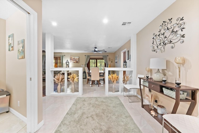 living area featuring light tile patterned floors, visible vents, baseboards, recessed lighting, and a ceiling fan