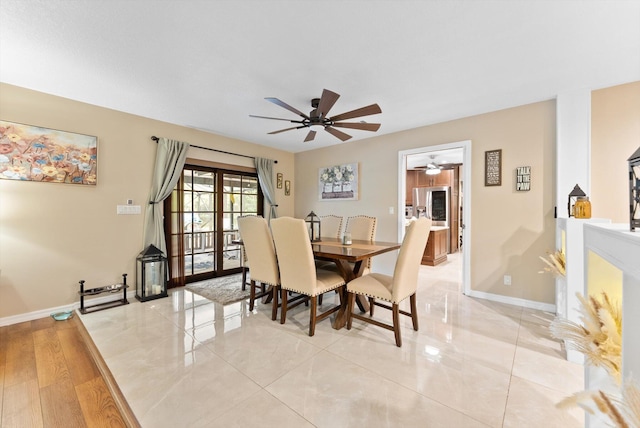 dining room with ceiling fan and baseboards