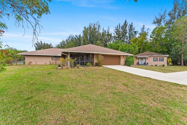 ranch-style house with a garage, concrete driveway, a front yard, and a sunroom