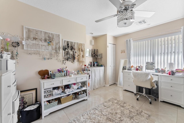 office area with light tile patterned floors, ceiling fan, and visible vents